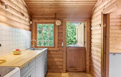 a kitchen with wooden walls and a wooden door at Lovely Home In Højslev With Kitchen in Lundø