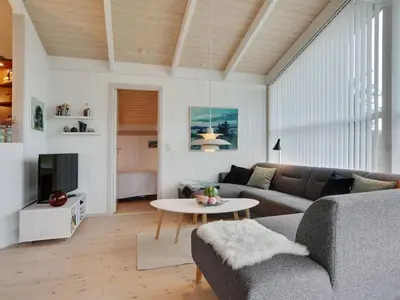 a living room with a couch and a table at Holiday Home Lennja - 300m from the sea by Interhome in Saltum