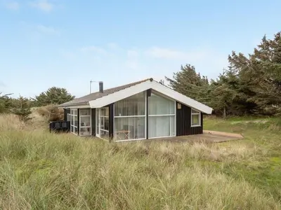 a small house in the middle of a field at Holiday Home Lennja - 300m from the sea by Interhome in Saltum