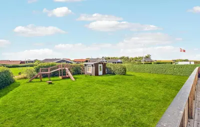 a garden with a playground and a house at Stunning Home In Vinderup With Kitchen in Vinderup