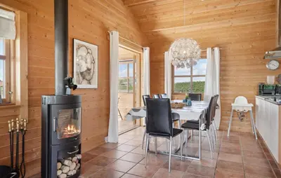 a dining room with a fireplace and a table and chairs at Stunning Home In Vinderup With Kitchen in Vinderup