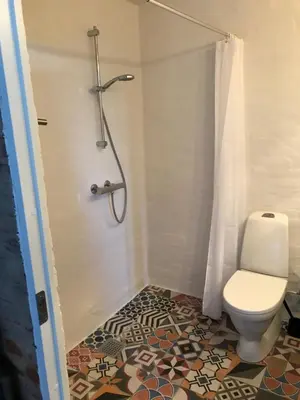 a bathroom with a toilet and a shower at Holstebro Sky Studio in Holstebro