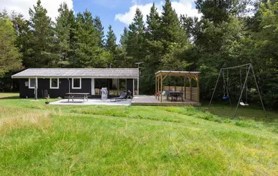 a small cabin with a playground and a swing at Nice Home In Højslev With Kitchen in Højslev