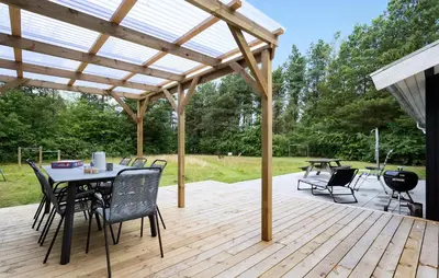 a patio with a table and chairs under a pergola at Nice Home In Højslev With Kitchen in Højslev
