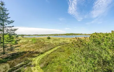 a grassy field with a lake in the background at Nice Home In Højslev With Kitchen in Højslev