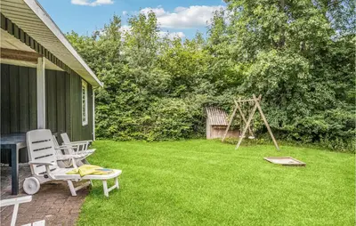 a yard with a chair and a swing at Holiday Home Illeris Farsø Vi in Farsø
