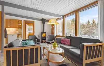 a living room with a couch and a table at Holiday Home Illeris Farsø Vi in Farsø