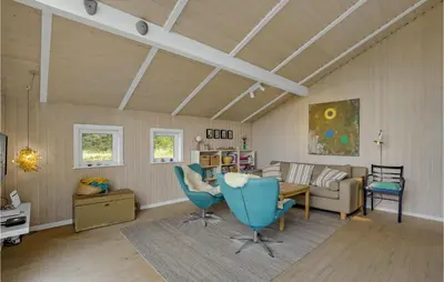 a living room with a couch and a table and chairs at Holiday Home Bavnbak Thisted Iv in Thisted