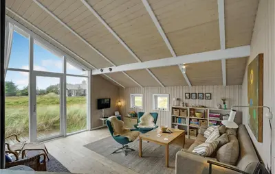 a living room with a couch and a table at Holiday Home Bavnbak Thisted Iv in Thisted