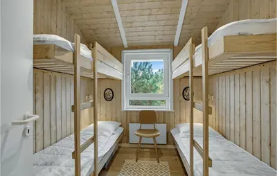 a room with four bunk beds and a window at Holiday Home Bavnbak Thisted Iv in Thisted