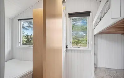 a small room with a bed and two windows at Awesome Home In Saltum With Wifi in Saltum