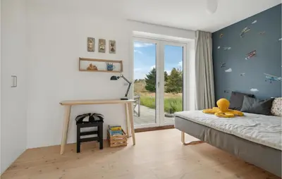 a bedroom with a bed and a desk and a window at Nice Home In Fjerritslev With Wifi in Fjerritslev
