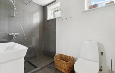 a bathroom with a shower and a toilet and a sink at Nice Home In Fjerritslev With Wifi in Fjerritslev