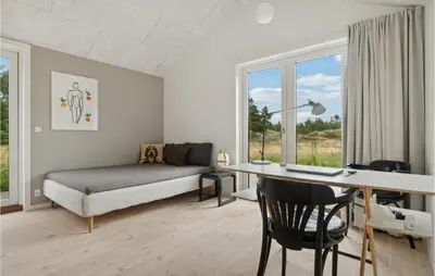 a living room with a desk and a couch and a bed at Nice Home In Fjerritslev With Wifi in Fjerritslev