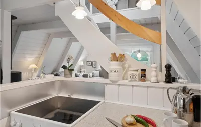 a kitchen with a sink and a staircase at Gorgeous Home In Farsø With Kitchen in Farsø