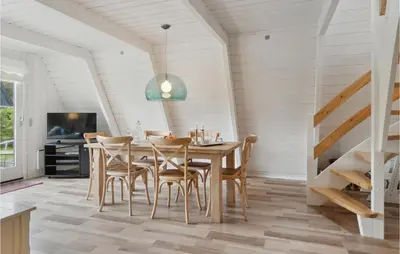 a dining room with a wooden table and chairs at Gorgeous Home In Farsø With Kitchen in Farsø