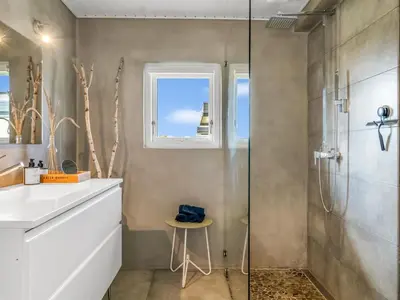 a bathroom with a shower and a sink at Holiday Home Tarvo - 400m from the sea by Interhome in Pandrup
