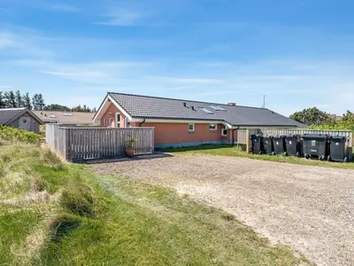 a house with a fence and a yard at Holiday Home Jenvold - 600m from the sea by Interhome in Torsted
