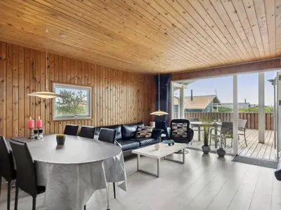 a living room with a couch and a table at Holiday Home Wolter - 700m from the sea by Interhome in Harboør