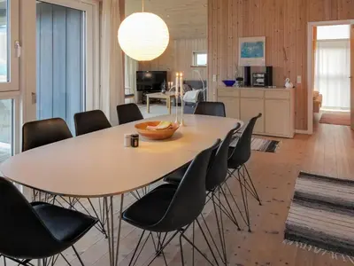 a dining room with a table and chairs at Holiday Home Ilkka - 400m from the sea by Interhome in Torsted