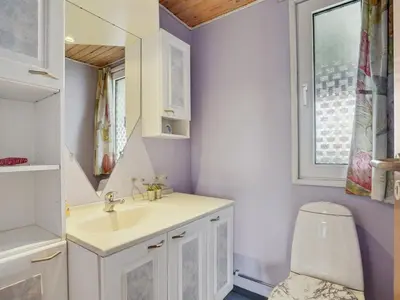 a bathroom with a sink and a toilet at Holiday Home Ormar - 100m to the fjord by Interhome in Lemvig