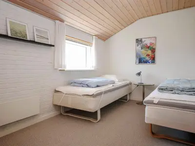 a bedroom with two beds and a window at Holiday Home Hilmer - 250m from the sea by Interhome in Torsted