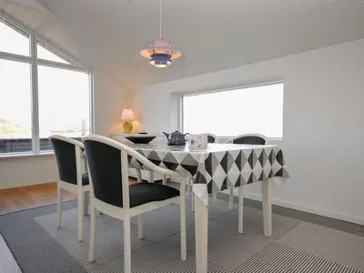 a dining room with a black and white table and chairs at Holiday Home Hilmer - 250m from the sea by Interhome in Torsted