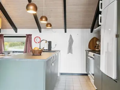 a kitchen with wooden ceilings and a counter top at Holiday Home Myrte - 900m from the sea by Interhome in Torsted