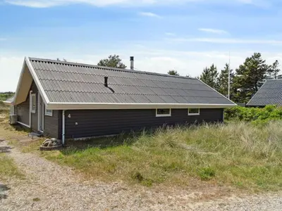 a house with a metal roof on a field at Holiday Home Myrte - 900m from the sea by Interhome in Torsted