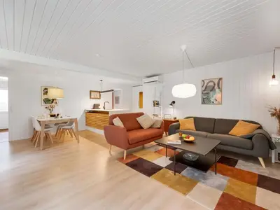 a living room with a couch and a table at Holiday Home Gudrid - 250m to the fjord by Interhome in Højslev