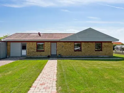 a brick house with a green lawn in front of it at Holiday Home Ingward - 750m from the sea by Interhome in Vestervig