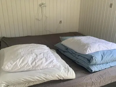 two pillows sitting on a bed in a room at Holiday Home Bjerne - 250m to the fjord by Interhome in Roslev