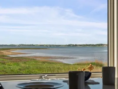 a view of the ocean from a window at Holiday Home Swaantje - 150m to the fjord by Interhome in Fur