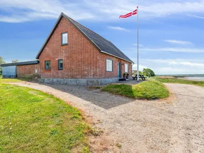 a red brick building with a flag on it at Holiday Home Swaantje - 150m to the fjord by Interhome in Fur