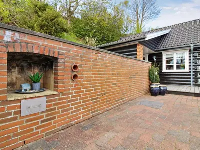a brick wall in front of a house at Holiday Home Sander - 10m to the fjord by Interhome in Roslev