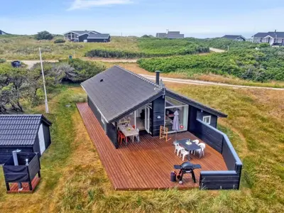 an overhead view of a house with a wooden deck at Holiday Home Alma - 500m from the sea by Interhome in Løkken