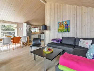 a living room with a couch and a table at Holiday Home Alma - 500m from the sea by Interhome in Løkken