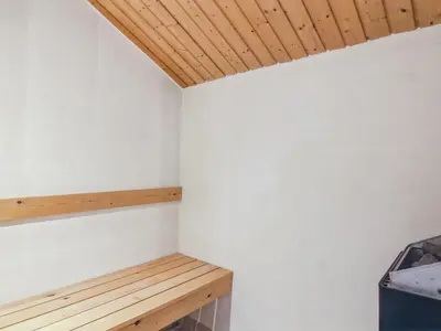 a room with white walls and a wooden ceiling at Holiday Home Ran - 1-5km from the sea by Interhome in Saltum