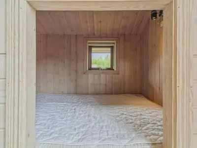 a bed in a room with a window at Holiday Home Ran - 1-5km from the sea by Interhome in Saltum