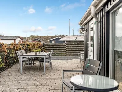 a patio with a table and chairs on a balcony at Holiday Home Kielo - 200m to the fjord by Interhome in Løgstør