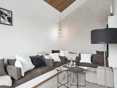 a living room with a couch and a table at Holiday Home Bena - 800m from the sea by Interhome in Blokhus