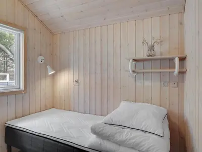 a small room with a bed and a window at Holiday Home Aneline - 700m from the sea by Interhome in Saltum
