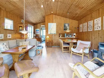 a living room with a couch and a table at Holiday Home Gerasim - 1km from the sea by Interhome in Saltum