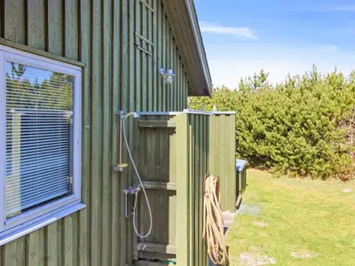 a shower on the side of a house at Holiday Home Gerasim - 1km from the sea by Interhome in Saltum