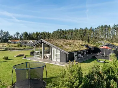 an image of a house with a grass roof at Holiday Home Sazdo - 1-1km from the sea by Interhome in Saltum