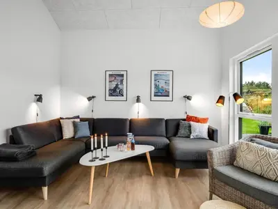 a living room with a couch and a table at Holiday Home Egil - 1-5km from the sea by Interhome in Saltum
