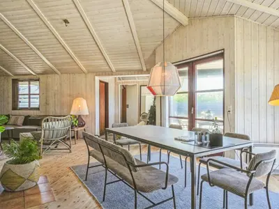 a dining room with a table and chairs at Holiday Home Fridgerd - 250m from the sea by Interhome in Blokhus