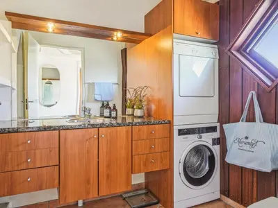 a bathroom with a washing machine and a washer and dryer at Holiday Home Fridgerd - 250m from the sea by Interhome in Blokhus