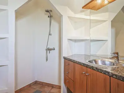a bathroom with a sink and a shower at Holiday Home Fridgerd - 250m from the sea by Interhome in Blokhus