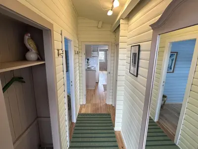 a hallway of a tiny house with a green and white rug at Holiday Home Freding - 450m from the sea by Interhome in Løkken
